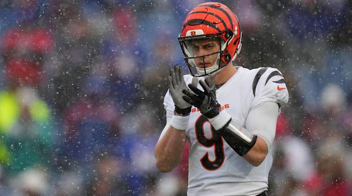 Bengals quarterback Joe Burrow warms up before an NFL divisional playoff football game.